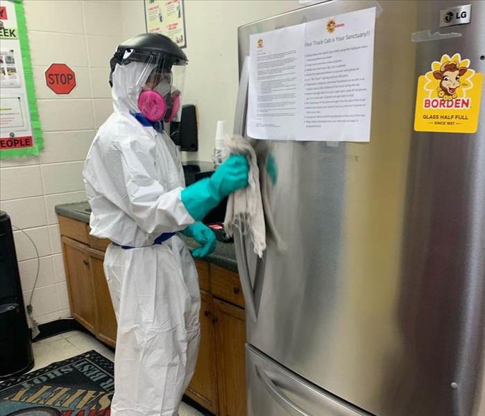 cleaning and sanitizing refrigerator in an office