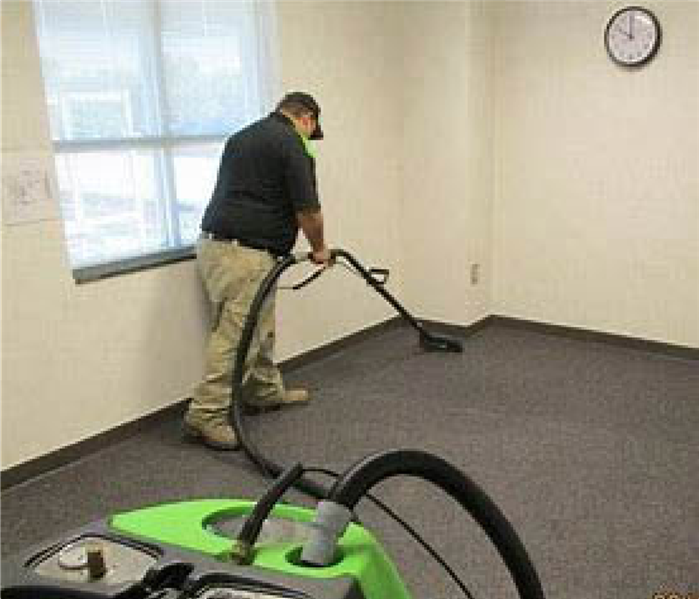 Man extracting water from carpets.