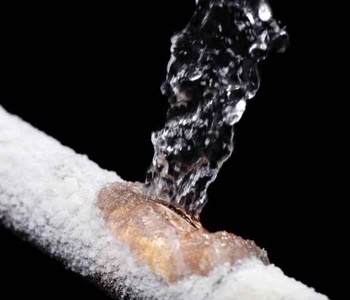 a frozen pipe with water coming out 