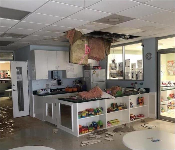 Ceiling collapsed, insulation hanging from ceiling. Concept of water damage